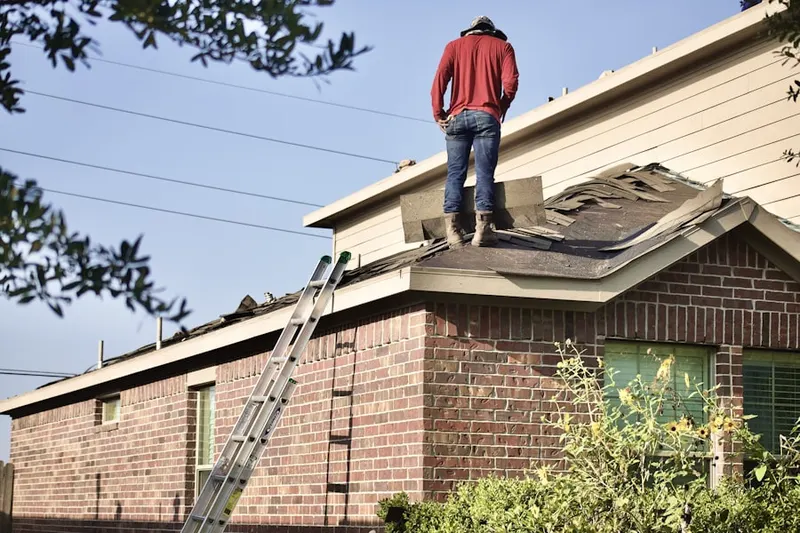 Professional roofer working on a residential roof in Wanamassa